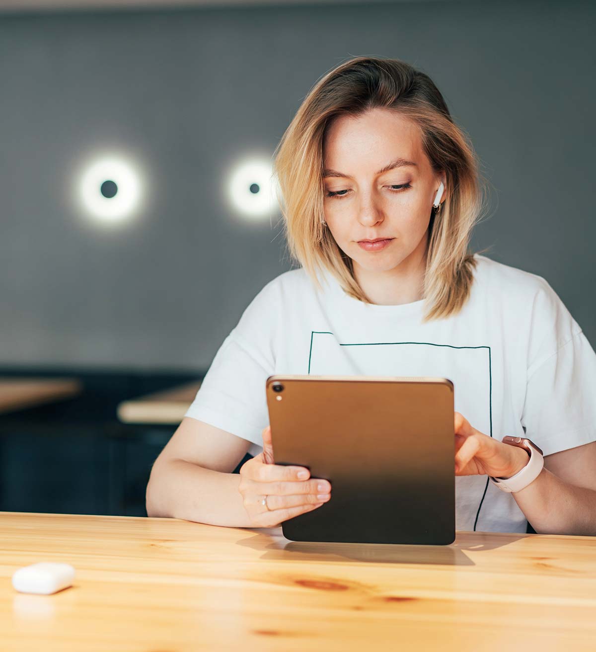 young-caucasian-woman-working-on-a-touchscreen-tab-2022-11-15-09-35-18-utc